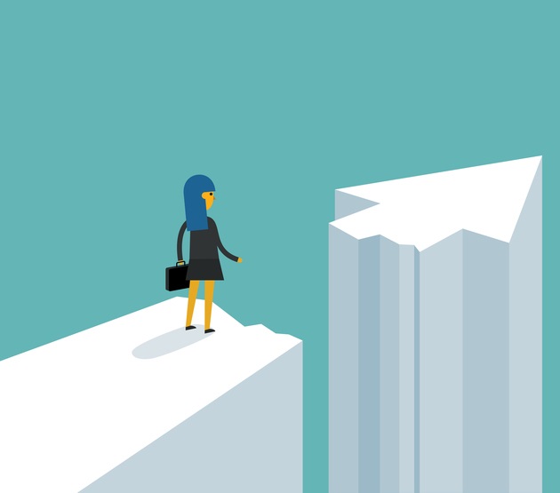 Businesswoman on standing between chasm and success