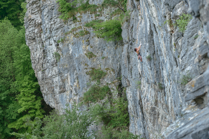 Rock climber high up on the climbing crag