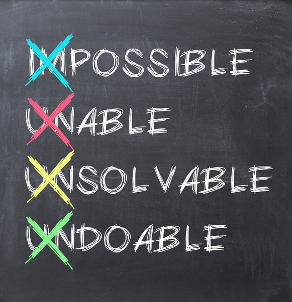 4 words written on a chalkboard, all with the first 2 letters crossed out with an "x": "Impossible", "Unable", "Unsolvable", and "undoable"