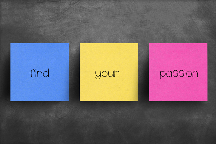 A chalkboard with 3 different colored sticky notes spelling out "find your passion"